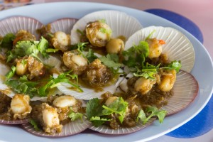 Grilled scallop with sauce in shell